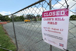 A closed for construction sign on a chain-link fence for Carr's Hill Fields