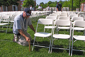 Employee aligning special event chairs