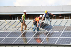 Crew installing solar panels on a roof